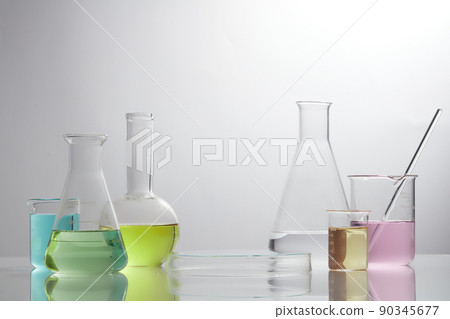 Front view of laboratory equipment filled with colorful fluid in a beaker test tube in lab background for experiment advertising 90345677