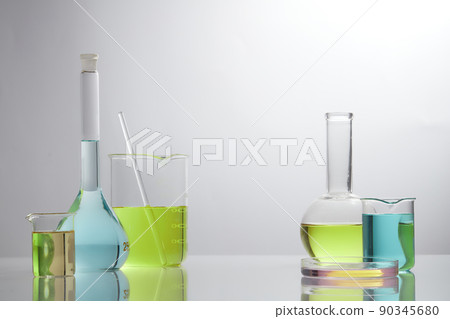 Front view of laboratory equipment filled with colorful fluid in a beaker test tube in lab background for experiment advertising 90345680