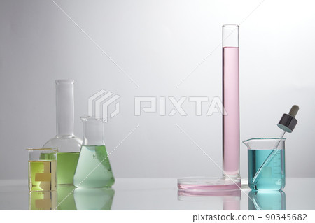 Front view of laboratory equipment filled with colorful fluid in a beaker test tube in lab background for experiment advertising 90345682