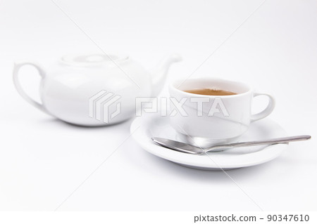 a white tea set with teapot tea and saucers and pie for breakfast 90347610