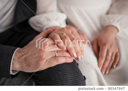woman's hand on a chair with a golden ring at the bride woman's hand on a chair with a golden ring at the bride 90347847