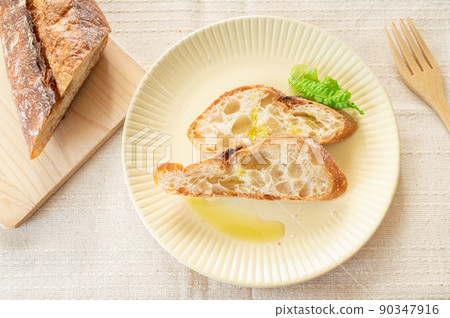 Baguette and olive oil Baguette and olive oil 90347916