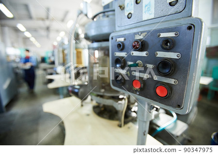 Close-up of control panel of clock movement machine with black and red buttons and small switch Close-up of control panel of clock movement machine with black and red buttons and small switch 90347975