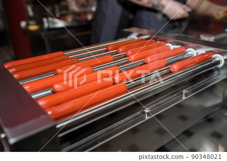 grilled hot dog sausages are fried in a restaurant 90348021
