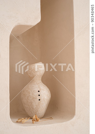 Ceramic handmade vase in a minimalist style on a shelf in the wall. Ceramic handmade vase in a minimalist style on a shelf in the wall. 90348465