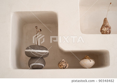 Handmade ceramic vases in a minimalist style on a shelf in the wall. 90348482