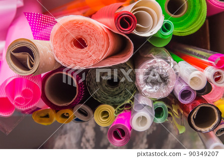 Rolled up plastic or polyethylene colored packaging object wrapper material Rolled up plastic or polyethylene colored packaging object wrapper material 90349207
