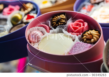 Beautiful delicious pastries on a showcase in a shop Beautiful delicious pastries on a showcase in a shop 90349263