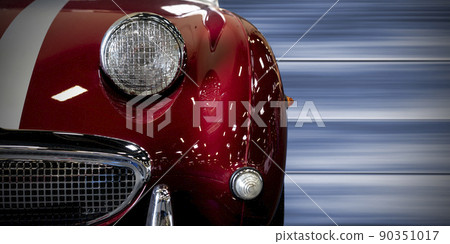 Front view of a vintage red car with speed background Front view of a vintage red car with speed background 90351017