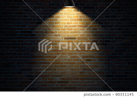 Dark brick wall illuminated by a lamp Dark brick wall illuminated by a lamp 90351145