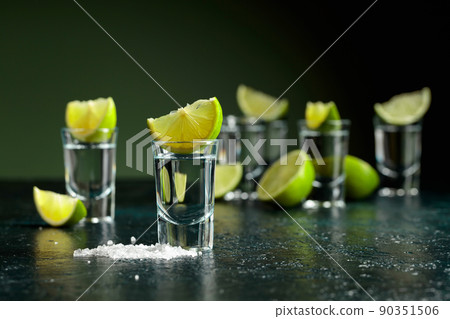 Tequila shots with lime slices and sea salt. 90351506