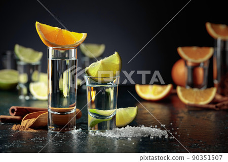 Tequila shots on a black background. Tequila shots on a black background. 90351507