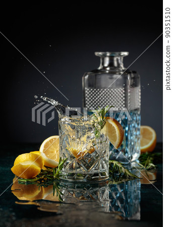 Gin tonic cocktail with lemon and rosemary. Gin tonic cocktail with lemon and rosemary. 90351510
