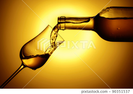 Digestive tulip of premium alcohol on a yellow background. 90351537