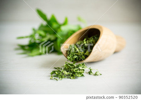 dried green organic arugula, seasoning, on a light background dried green organic arugula, seasoning, on a light background 90352520