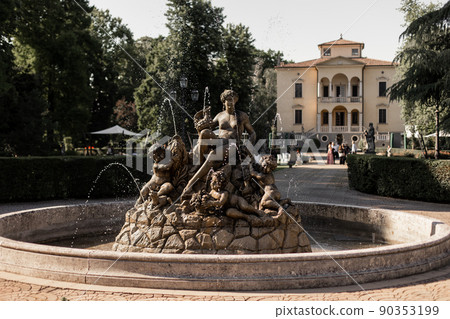 beautiful statue fountain on the territory of the chateau in italy beautiful statue fountain on the territory of the chateau in italy 90353199