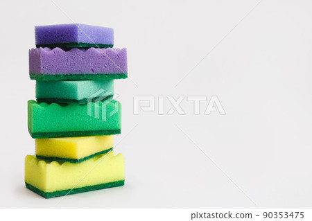 Stack of colored kitchen sponge isolated on white background Stack of colored kitchen sponge isolated on white background 90353475