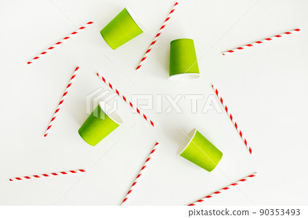 Green paper cups with striped paper straw flat lay on white background. Eco-friendly concept 90353493
