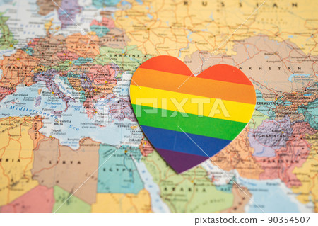 Bangkok, Thailand, June 1, 2022 Rainbow color heart on globe world map background,  LGBT pride month celebrate annual in June, symbol of gay, lesbian, bisexual, transgender, human rights and peace. 90354507