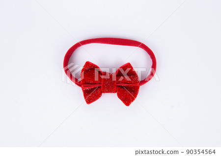 red bow hairpin decoration for a girl on a white background 90354564