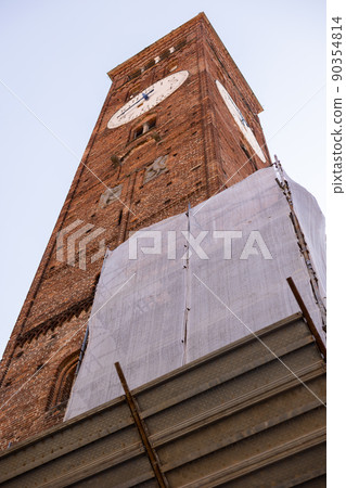 a brick tall old clock tower in italy city 90354814