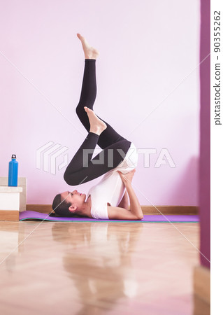 Young happy caucasian woman stretching in the living room  Health care and wellness at home concept. 90355262