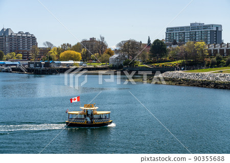 Victoria, BC, Canada - April 14 2021 : Water taxi on Victoria Inner Harbour. Victoria, BC, Canada - April 14 2021 : Water taxi on Victoria Inner Harbour. 90355688