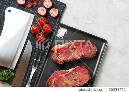 Marinated raw steaks on stone table with spices Marinated raw steaks on stone table with spices 90355711