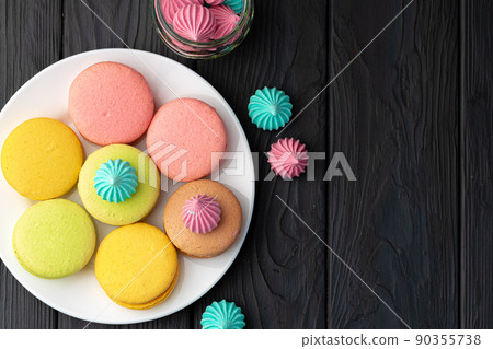 French macaroon cookies of bright colors served in white ceramic plate French macaroon cookies of bright colors served in white ceramic plate 90355738