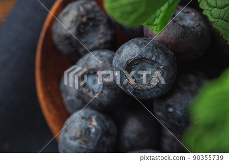 Bowl of fresh blueberry on kitchen table close up Bowl of fresh blueberry on kitchen table close up 90355739