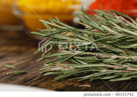 Dried rosemary branches on kitchen table close up Dried rosemary branches on kitchen table close up 90355742
