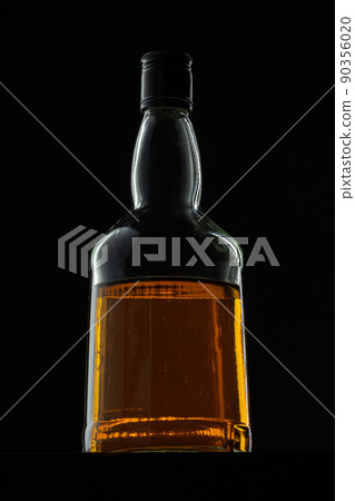 Bottle of whisky on black background, copy space 90356020