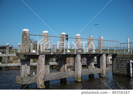 Den Helder, Netherlands, May 2022. Locks and mooring posts at Oostoever in Den Helder. Den Helder, Netherlands, May 2022. Locks and mooring posts at Oostoever in Den Helder. 90356167