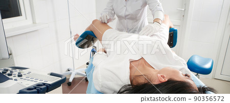 Cropped panorama of gynecologist examining a patient who is sitting in a gynecological chair. Female health concept. 90356572