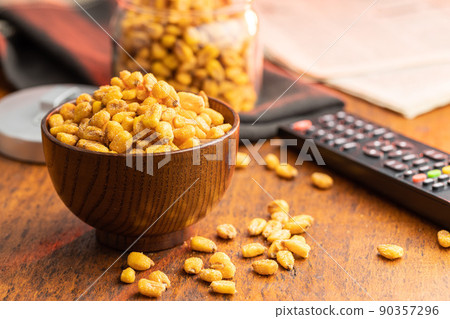 Roasted salted corn snack in bowl on wooden table. Roasted salted corn snack in bowl on wooden table. 90357296