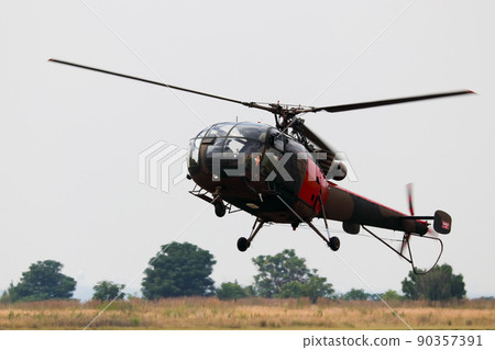 Light Military Helicopter Coming In To Land 90357391