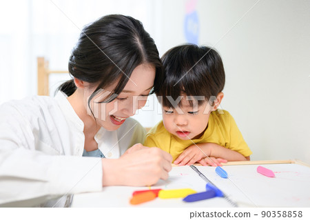 Mom drawing a picture with a toddler Mom drawing a picture with a toddler 90358858