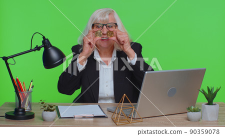 Elderly businesswoman showing golden bitcoins BTC, money mining, investment, wealth, earning, income 90359078