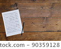 Sheet music and pencil on a wooden board 90359128
