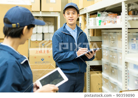 A young staff man working in a warehouse A young staff man working in a warehouse 90359890