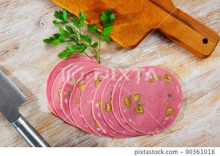 Image of mortadela sausage with olives cut in slices 90361018