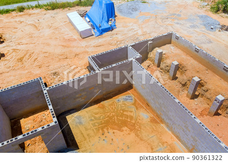 Construction mason concrete blocks foundation for new house building an aerial top view 90361322
