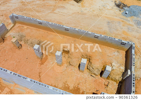 Block wall foundation from a new family house on construction site Block wall foundation from a new family house on construction site 90361326