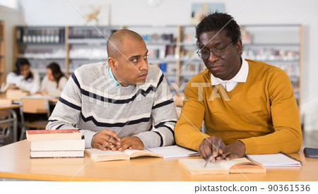 Adult men gaining skills at public library 90361536