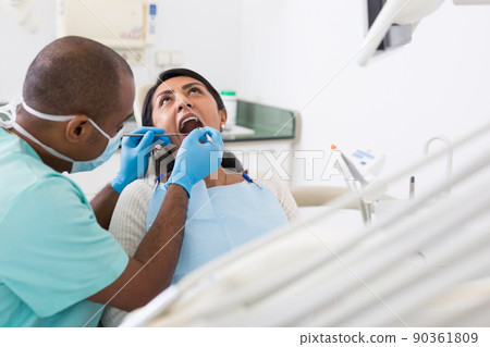 Female patient during dental checkup in dentist office Female patient during dental checkup in dentist office 90361809