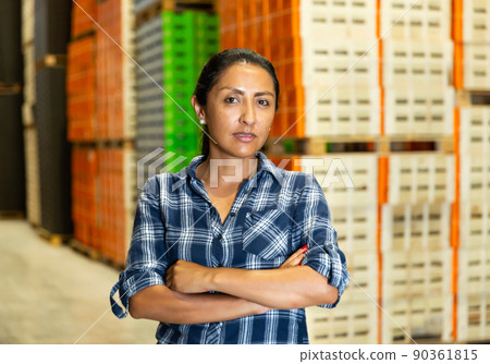 Portrait of worker with arms crossed standing in warehouse Portrait of worker with arms crossed standing in warehouse 90361815