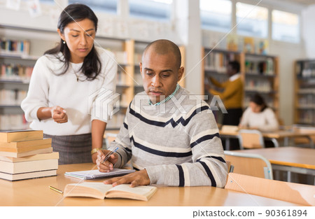 Adult people gaining skills at public library Adult people gaining skills at public library 90361894
