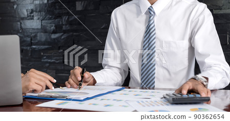 Two business leaders talk about charts, financial graphs showing results are analyzing and calculating planning strategies, business success building processes 90362654