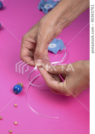 The female hands of the master assemble a handmade product from felted wool The female hands of the master assemble a handmade product from felted wool 90363761