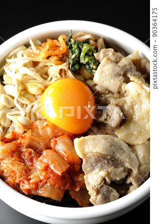 黑色背景中包含豆芽、泡菜和豬肉等大量配料的拌飯碗的鳥瞰圖。 黑色背景中包含豆芽、泡菜和豬肉等大量配料的拌飯碗的鳥瞰圖。 90364175